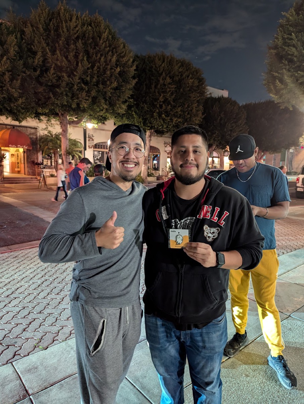 Two smiling trainers with the Dalix giveaway prize in Downtown Fullerton